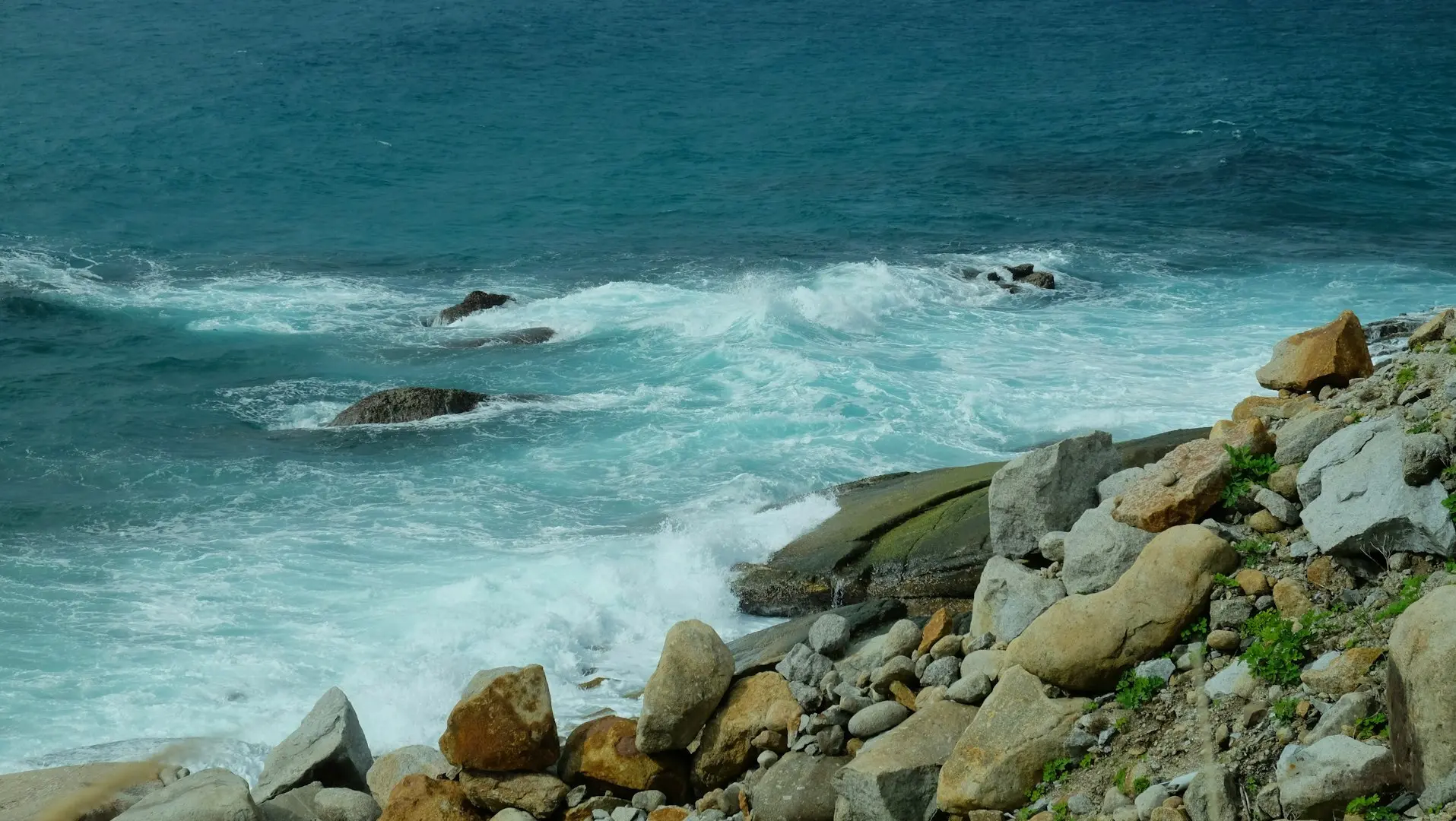 a couple of rocks that are by the water