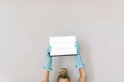 girl in teal t-shirt holding white paper